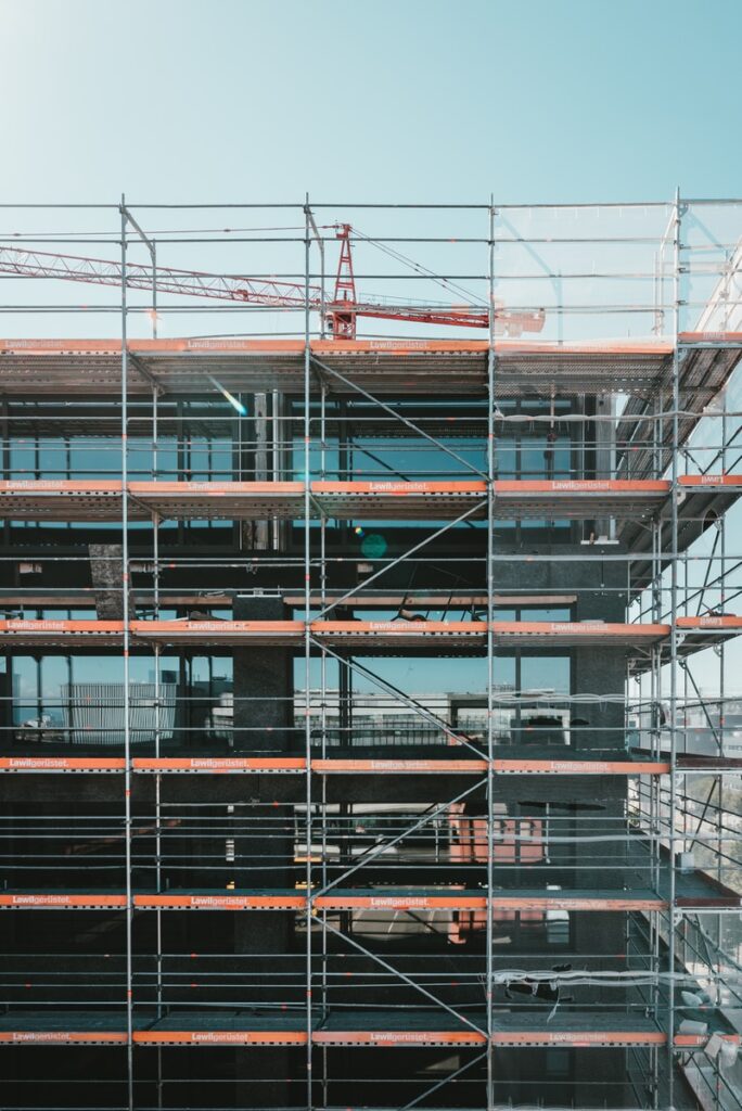 scaffolding near brown and beige building